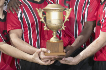 Soccer players holding trophy