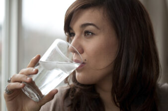 Young woman drinking a glass of water