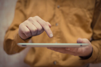 person's hand on a tablet