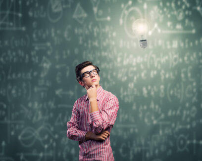 intelligent man in glasses thinking with lightbulb over his head