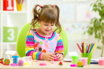 happy little girl doing crafts