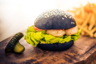 Modern black burger with squid ink buns and shrimps