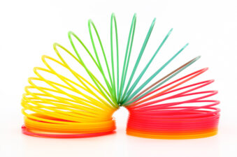 multi-colored rainbow slinky on white background