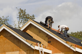 Roofers putting down sheets