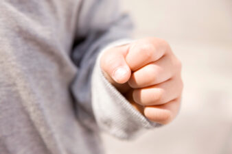 child's hand in a fist