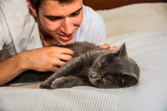 Man talking to and petting his cat