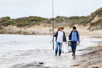 Fishermen walking together on the beach