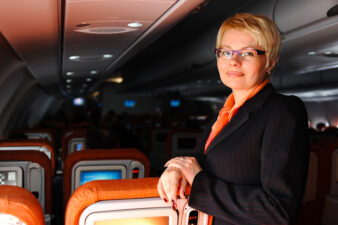 Business woman posing in modern jet aircraft