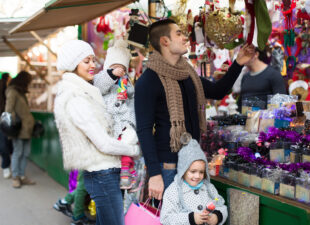 Happy family of four at Christmas market