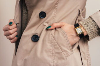 Woman putting her hand in pocket of khaki jacket