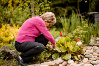 Senior woman pruning flowers