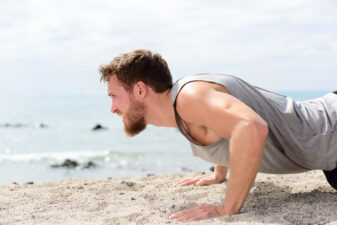 Man doing push-ups on the beach