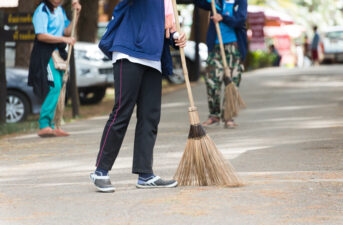 Man sweeping the sidewalk