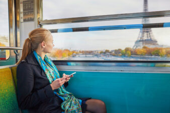 Woman looking at the Eiffel Tower on train