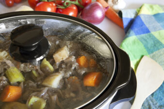 A crock pot slow-cooking a beef casserole