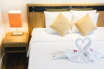 Comfy hotel rom bed with decorative towels