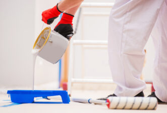 Person wearing white working on a painting job