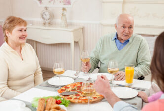 Cute old people are dining with their relatives