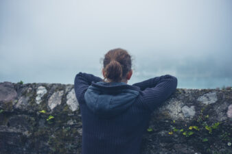 young woman looking out at the water