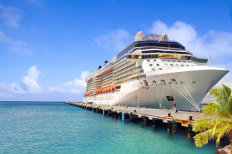 Luxury cruise ship in port on sunny day