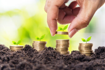 Man handing stacking coins for investing