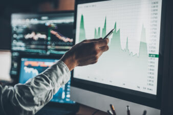 hand analyzing data on a laptop screen