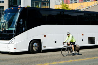 Cyclist and luxury bus