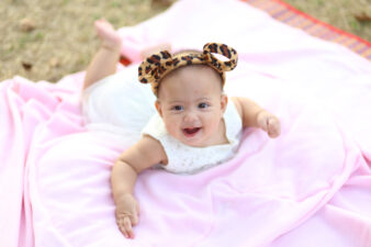 Little girl smiling with cute cheetah print ears