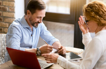 Business man and woman speaking together at a meeting