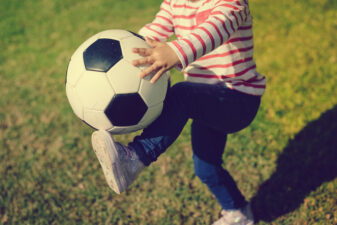 Kid hitting a soccer ball