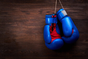 Blue boxing gloves on wood background