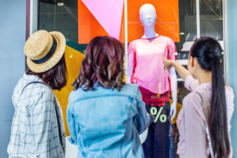 women looking at a mannequin