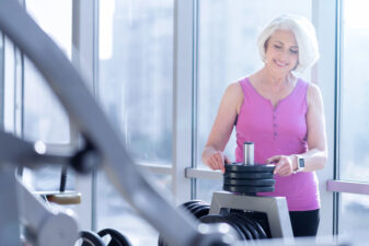 Senior lady working out at the gym