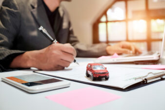 Man signing car warranty