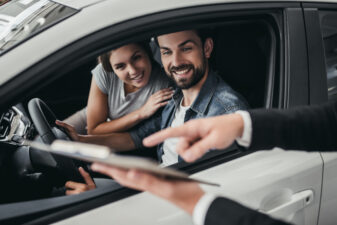 Couple at car dealership