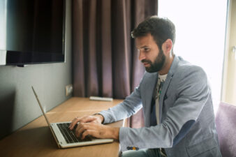 Man typing at his laptop