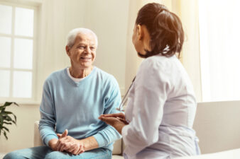 happy man speaking with his female doctor