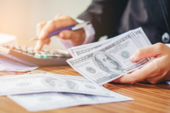 Man's hand holding cash