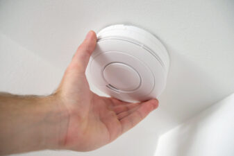 Man installing smoke detector