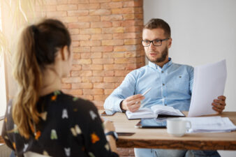 man speaking with a woman in an interview