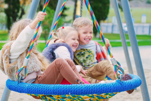 three children playing in the park