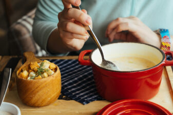 person eating a bowl of soup