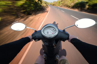 Driving a scooter down the road