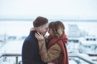 Young couple embracing in scenic winter landscape