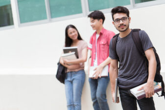 student and friends holding their books