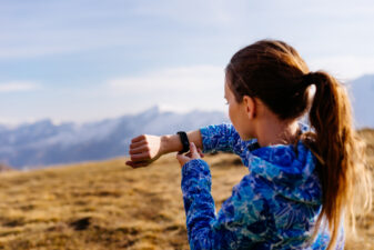 Woman looking at her wrist pedometer