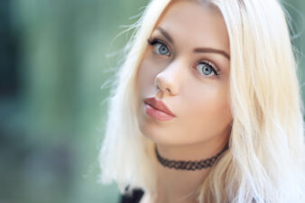 blonde girl wearing a black choker necklace