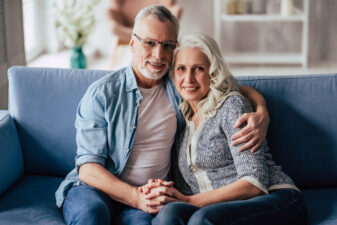 Senior couple at home on couch