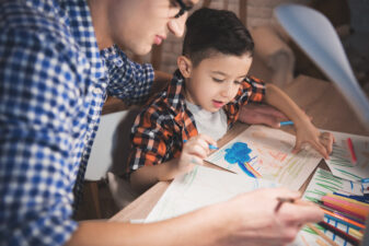 Father and son creating a storybook together