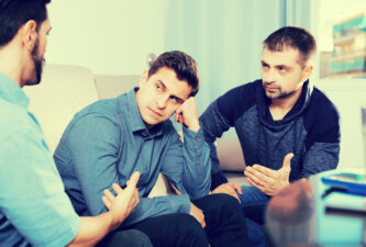 Upset friends talking on couch